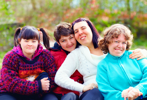 group of happy women with disability having fun in spring park